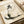 May include: Framed zen-style artwork featuring a minimalist black ink painting of a sleeping cat in traditional Japanese sumi-e brush stroke style on aged cream paper, with black calligraphy characters above, displayed on a light wooden surface next to rolled cream-colored papers