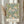 May include: Framed botanical poster with vintage William Morris floral pattern featuring pink chrysanthemums, blue and green foliage on cream background, displayed on white wall beside dried pampas grass stems and neutral curtains in soft natural lighting.