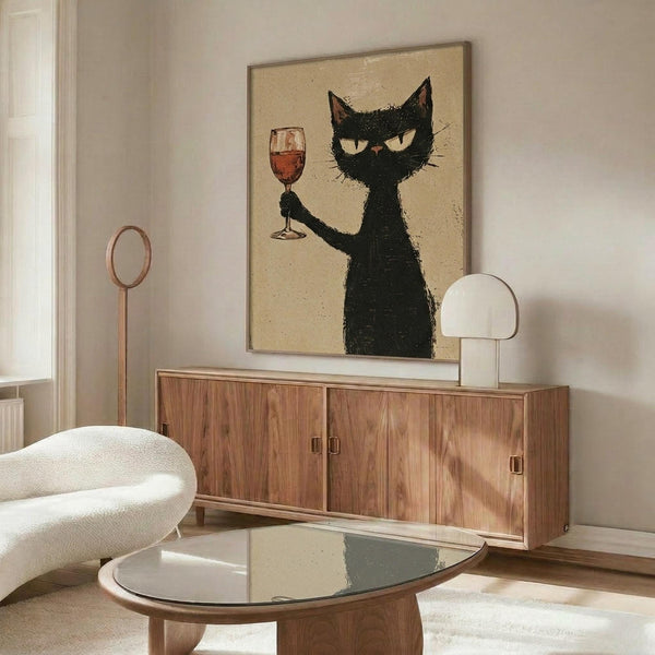 May include: Framed poster of black cat holding wine glass on beige background, displayed above wooden credenza in modern living room with white curved chair, glass coffee table, and minimalist decor