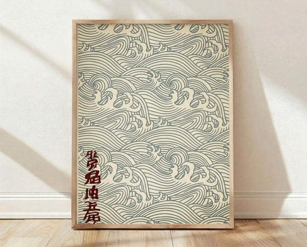 May include: Framed poster with traditional Japanese wave pattern in sage green lines on cream background, featuring repeating ocean waves and stylized water motifs. Dark red Japanese characters appear in bottom left corner. Natural wood frame leans against white wall on light wooden floor with soft natural lighting casting shadows.
