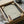 May include: Framed Japanese wave pattern artwork in cream and teal colors featuring flowing curved lines and traditional seigaiha design, displayed in black frame within cardboard packaging box with protective wrapping materials and wooden handles visible