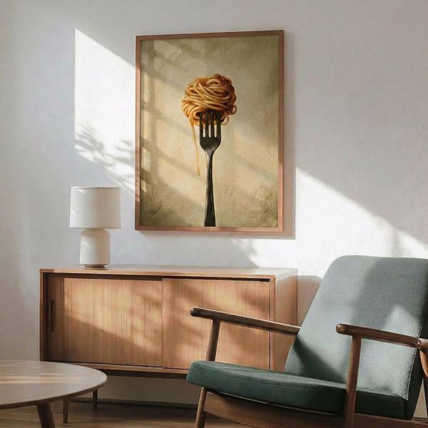 May include: Framed poster print featuring pasta wrapped around a fork against a beige background, displayed above a wooden credenza in a modern living room with mid-century furniture, white table lamp, and sage green upholstered chair. Natural sunlight creates geometric shadows on white walls.