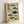May include: Framed vintage-style Japanese scientific illustration showing eight different pufferfish species in various colors including brown, green, and teal against cream background. Features traditional Japanese calligraphy and red seal stamps. Light wood frame leaning against white wall, casting subtle shadow.