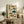 May include: Vintage-style Japanese scientific chart displaying various pufferfish species in different colors including brown, green, and blue tones with Japanese text and red stamps. Framed artwork sits on rustic wooden console alongside fern plant, books, and ceramic vase in neutral-toned living room setting.