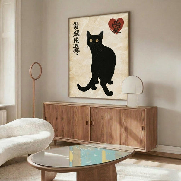 May include: Black cat poster with Japanese characters and red heart displayed above wooden sideboard in modern living room. Artwork shows silhouetted cat sitting upright on cream vintage-style background. Room features white curved chair, oval glass coffee table with colorful abstract design, and warm wood furniture against neutral walls.