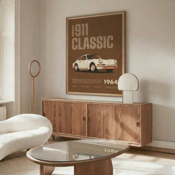 May include: Brown vintage-style poster featuring classic white Porsche 911 sports car with "911 CLASSIC" text and "1964" year marking, displayed in wooden frame above mid-century modern walnut credenza. Room shows white upholstered chair, brass floor lamp, white table lamp, glass-top coffee table, and neutral walls with natural lighting.