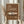 May include: Framed vintage-style poster with brown background featuring cream-colored Porsche 911 classic car illustration and "1964" text, held by person in beige clothing with dried pampas grass, photographed against neutral curtained window background in natural lighting