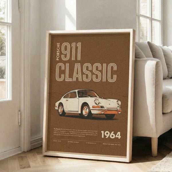 May include: Framed vintage-style poster featuring white classic sports car on brown background with cream text reading "911 CLASSIC" and "1964", displayed on wooden floor against beige couch in bright living room with white walls and windows
