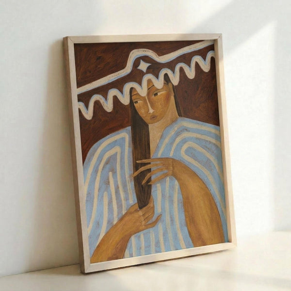 Framed artwork leaning against white wall showing a figure with long dark hair wearing blue and white striped clothing, painted in warm earth tones with stylized wavy lines above. The piece features a brown background with geometric patterns and is displayed in a light wood frame.