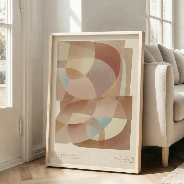 May include: Abstract geometric art print in warm earth tones featuring overlapping translucent circles and curved shapes in terracotta, sage green, cream, and dusty pink. The framed poster leans against a white wall next to a beige upholstered sofa in a bright, minimalist living room with large windows and natural light casting soft shadows on the floor.