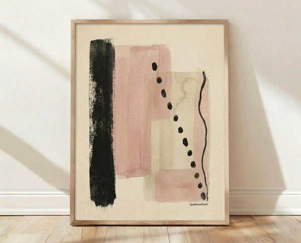 May include: Abstract art print in thin wooden frame leaning against white textured wall on light wood floor. Artwork features vertical black brushstroke on left, overlapping pink and sage green watercolor rectangles in center, vertical row of black dots, and curved black line on right, all on cream background.