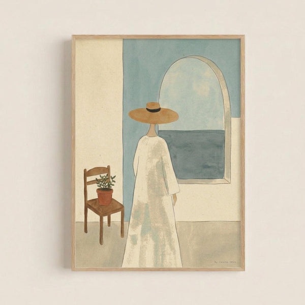 Framed art print showing a minimalist illustration of a figure in a white dress and wide-brimmed hat standing in front of an arched window overlooking the sea. A wooden chair with a small potted plant sits nearby. The artwork features soft, muted colors in sage green, cream, and warm earth tones with a contemporary, peaceful aesthetic. The print is displayed in a light wood frame against a white wall.