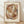 May include: Framed abstract art print with overlapping curved shapes in warm earth tones including terracotta, olive green, dusty blue, and cream. The geometric composition features translucent organic forms creating layered depth. Set in natural wood frame with cream matting, leaning against white textured wall on light wooden floor with soft natural lighting casting diagonal shadows.