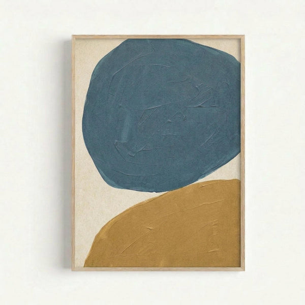 Framed abstract artwork featuring two large organic shapes - a teal blue irregular circle in the upper portion and a golden mustard curved form in the lower right corner, both painted with visible brushstrokes against a cream textured background, displayed in a light wood frame on a white wall.