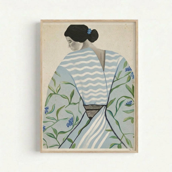 Framed artwork showing a woman in profile wearing a blue and white striped kimono with green botanical motifs and small blue flowers. She has black hair styled in a traditional updo with a blue hair ornament. The kimono features wavy horizontal stripes on the upper portion and delicate vine patterns with berries on the sleeves. The piece has a soft, muted color palette against a cream background and is displayed in a light wooden frame on a white wall.