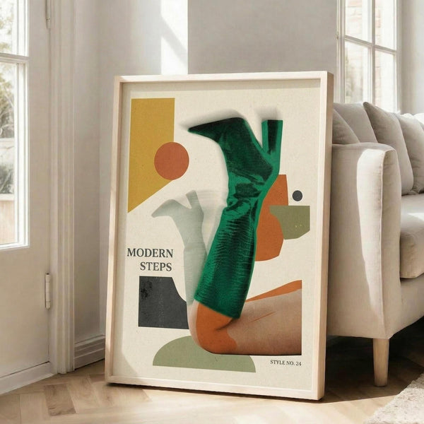 May include: Large framed abstract art print leaning against white wall next to beige sofa in bright living room. Poster features geometric shapes in yellow, orange, green, and black with "MODERN STEPS" text. White mat and light wood frame. Natural sunlight streams through tall windows onto hardwood floors.