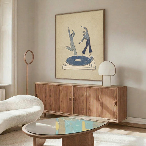 May include: Framed beige poster with blue illustrated figures dancing on a turntable, displayed above a walnut mid-century credenza with brass hardware. Modern white curved chair and round glass coffee table with colorful abstract art visible. White mushroom table lamp and brass floor lamp complete the minimalist living room scene with natural lighting.