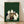 May include: Framed poster print leaning against white wall on light wood floor. Green textured background with five cats sitting around wooden table playing board game with chess pieces and poker chips. Cats include white, black and white, striped, and cream colored varieties in vintage illustration style. Natural wood frame.