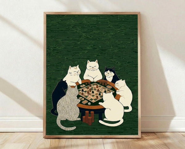 May include: Framed poster print leaning against white wall on light wood floor. Green textured background with five cats sitting around wooden table playing board game with chess pieces and poker chips. Cats include white, black and white, striped, and cream colored varieties in vintage illustration style. Natural wood frame.