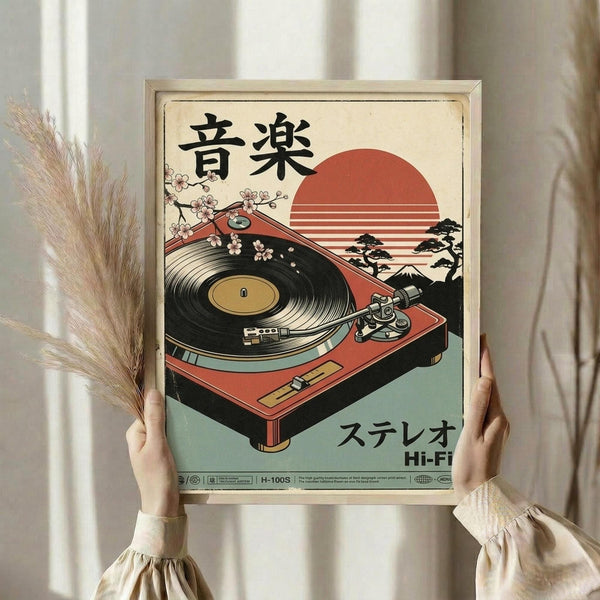 May include: Person holding a framed vintage-style poster featuring a red turntable with cherry blossoms and Japanese text against a sunset backdrop. The artwork has a retro aesthetic with muted colors on cream background. Person wears beige clothing and holds dried wheat stems, standing near white curtained window.