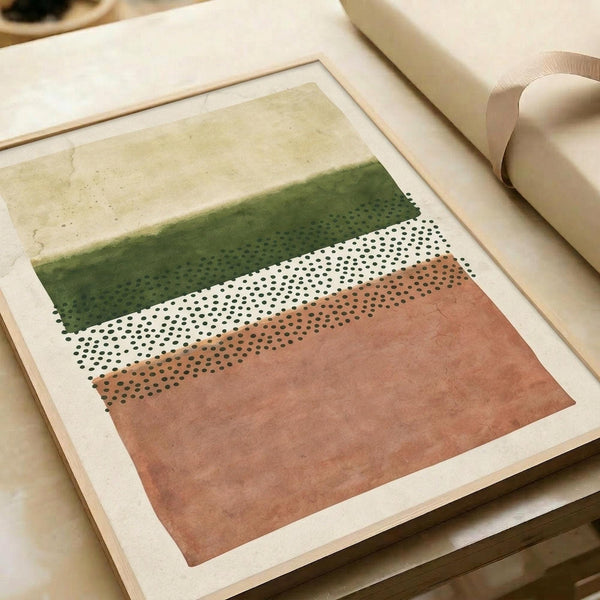 May include: Abstract geometric print displayed in light wood frame on white surface next to rolled paper tube. Artwork features horizontal bands of sage green watercolor wash at top, white section with black polka dot pattern in middle, and terracotta orange watercolor section at bottom, all on cream background with organic, painterly textures.