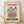 May include: Vintage-style poster with cream aged background featuring purple iris flowers and red blooms, text reading "Flower Market" in burgundy and "Amsterdam" in green, displayed in light wood frame leaning against white wall on wooden floor with natural lighting and soft shadows