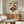 May include: Japanese-style poster featuring red turntable with cherry blossoms and rising sun, displayed above walnut credenza in modern living room with white curved chair, brass floor lamp, and glass-top coffee table on light wood floors
