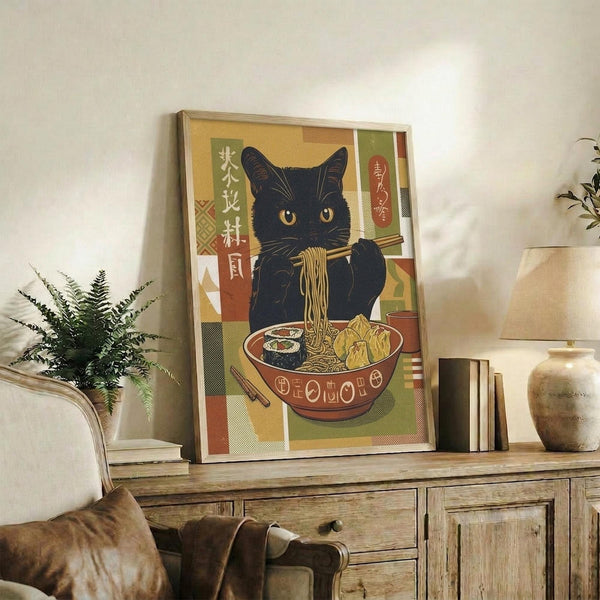 May include: Framed poster displaying a black cat with golden eyes eating ramen noodles from a red bowl, rendered in vintage Japanese art style with geometric patterns in warm earth tones. Print sits on rustic wooden credenza alongside books, ceramic vase, and fern plant in cozy living room setting with beige armchair and neutral walls.