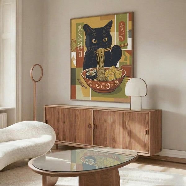 May include: Framed poster displaying a black cat with yellow eyes eating ramen noodles with chopsticks, featuring Japanese text and colorful geometric background in earth tones. Shown in modern living room with wooden credenza, white curved chair, glass coffee table, and warm natural lighting.