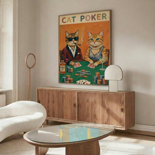 May include: Framed poster showing two cats dressed as humans playing poker at a green felt table with chips and cards, displayed above a mid-century modern walnut credenza in a contemporary living room with white walls, cream chair, and glass coffee table