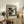 May include: Vintage-style poster featuring turntable with vinyl record displayed on wooden sideboard. Framed print shows retro stereo equipment in beige tones with Japanese text. Room scene includes potted fern, stacked books, ceramic vase, and brown leather furniture against cream walls.