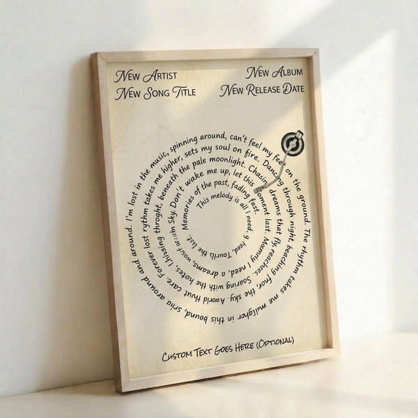 Cream-colored poster with light wood frame leaning against white wall. Text arranged in spiral pattern reads lyrics about being lost in music, spinning around, and dancing through dreams. Header shows placeholder text for artist, song title, album and release date in elegant script font. Small vinyl record icon in upper right corner. Bottom has space for custom text. Natural lighting creates soft shadows on textured paper surface.