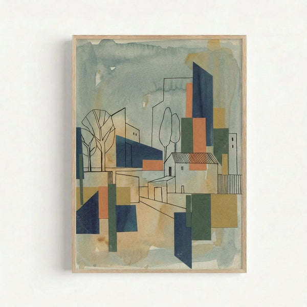 A framed abstract architectural watercolor painting featuring geometric buildings, trees, and structures in muted tones of blue, orange, green, and beige. The cubist-style artwork shows angular houses with chimneys, bare winter trees, and overlapping geometric shapes creating a modernist village scene. The painting is mounted in a light wood frame and displayed against a white wall, with visible watercolor texture and translucent layering effects throughout the composition.