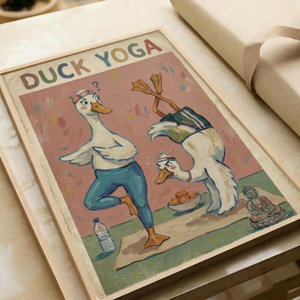 Two anthropomorphic ducks in yoga poses on a vintage-style poster with pink background. One duck in blue pants performs a standing pose with wings raised, while another duck in darker clothing sits in meditation position near a bowl of eggs. A small Buddha statue sits in the corner beside a water bottle. The poster has "DUCK YOGA" text at the top in colorful letters and appears to be displayed in an open book or portfolio with cream-colored pages.