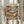 May include: Person holding framed vintage-style poster showing two orange tabby cats relaxing on tropical beach. One cat wearing sun hat and sunglasses lounges in hammock, other cat in Hawaiian shirt sits beside small table with wine glass and fish plate. Palm trees frame coral sunset sky over blue ocean. Book titled "The Art of Napping" lies on sandy beach with scattered items. Colorful "CAT NAP" text tops cream background poster in light wood frame.