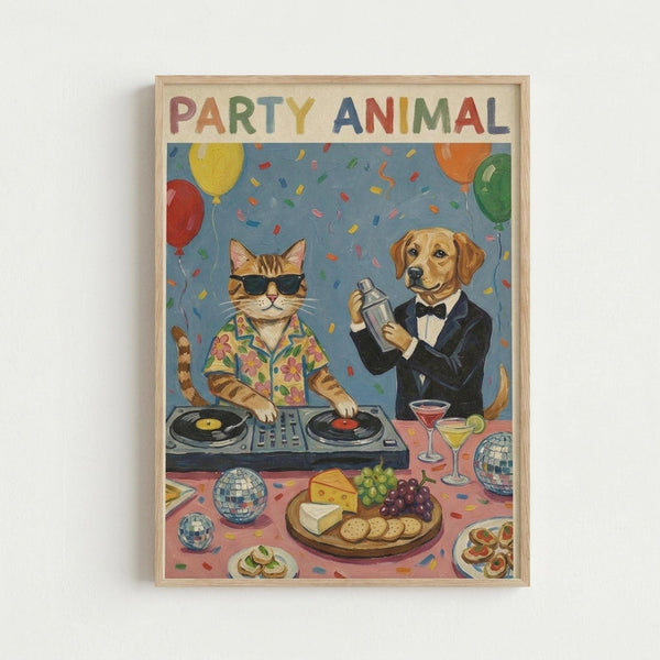 Framed poster artwork showing a cartoon cat wearing sunglasses and Hawaiian shirt operating DJ turntables while a golden retriever in a black tuxedo and bow tie holds a cocktail shaker. The scene includes colorful balloons, confetti, disco balls, cheese and grape platter, cocktail glasses, and appetizers on a party table. The title "PARTY ANIMAL" appears in multicolored letters at the top against a festive blue background with natural wood frame.