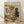 May include: Framed poster print leaning against white wall on light wood floor. Shows whimsical painted scene of brown dog wearing sunglasses and paint-splattered smock holding artist palette and brush, painting colorful abstract art on easel. Black cat in beret sits nearby. Wine bottle labeled "Vin Rouge Chat" with cheese and scattered papers on floor. "ART CRITIC" text at top in colorful letters. Light wood frame, vintage artistic style with warm tones.