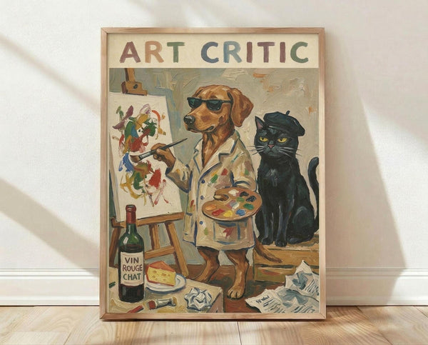 May include: Framed poster print leaning against white wall on light wood floor. Shows whimsical painted scene of brown dog wearing sunglasses and paint-splattered smock holding artist palette and brush, painting colorful abstract art on easel. Black cat in beret sits nearby. Wine bottle labeled "Vin Rouge Chat" with cheese and scattered papers on floor. "ART CRITIC" text at top in colorful letters. Light wood frame, vintage artistic style with warm tones.