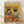May include: Framed poster print leaning against white wall on light wooden floor. Artwork shows two French bulldogs in colorful Mexican attire - one wearing striped serape and sombrero holding margarita, other in embroidered white top with flower crown. Orange background with festive Mexican food spread including tacos, guacamole, nachos, salsa, and tequila bottles on table.