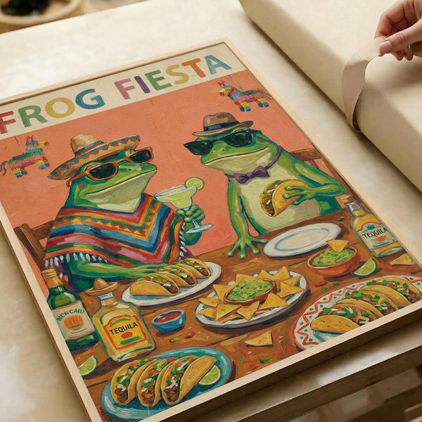 May include: Colorful illustrated poster showing two green frogs wearing sombreros and sunglasses at a Mexican feast, surrounded by tacos, nachos, guacamole, and tequila bottles. The orange-toned artwork features "FROG FIESTA" text at top with piñatas in background. Print appears mounted or displayed on white surface with hand lifting corner to show the artwork.