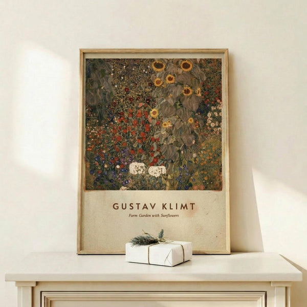 May include: Framed Gustav Klimt poster featuring a richly detailed garden scene with vibrant sunflowers, colorful wildflowers, and lush foliage in earthy greens, reds, and golds. The vintage-style print sits on a light wood shelf against a cream wall, with a small white wrapped gift adorned with an evergreen sprig placed beside it. The artwork displays Klimt's characteristic decorative style with intricate patterns and abundant botanical details.