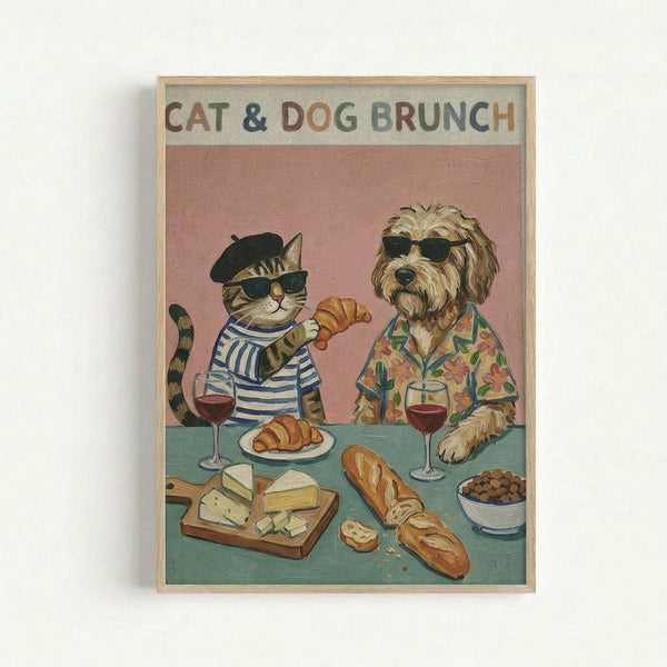 A framed vintage-style illustration shows a tabby cat wearing a black beret, striped shirt, and sunglasses sitting at a brunch table with a shaggy dog in sunglasses and a tropical Hawaiian shirt. The coral pink background contrasts with the teal table laden with croissants, cheese board, bread, wine glasses, and a bowl of what appears to be olives or berries. Both animals appear relaxed and sophisticated in this whimsical dining scene rendered in warm, muted tones with a light wooden frame.