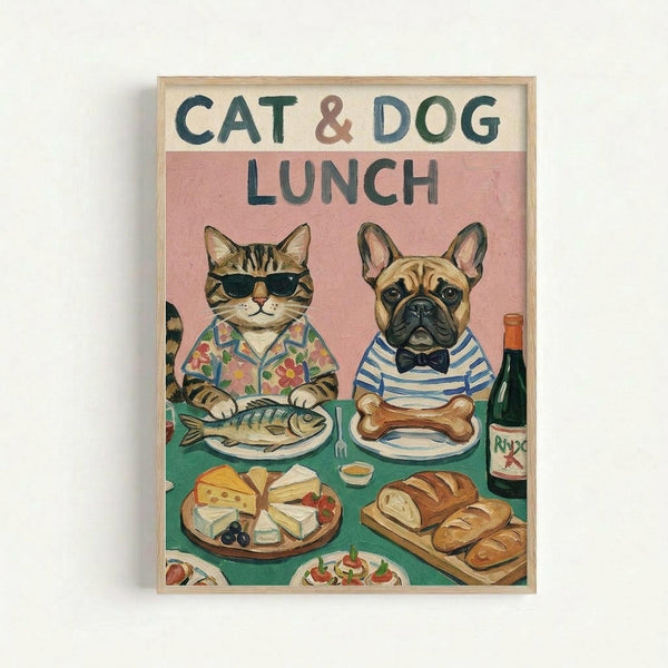 Whimsical illustration of a tabby cat wearing sunglasses and floral shirt sitting at a green table with a French bulldog in striped shirt and bow tie. The cat has a fish on its plate while the dog has a bone. The table displays cheese, bread, wine bottle, and other foods against a pink background. Artwork is displayed in a light wood frame on a white wall.