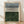 May include: Framed abstract art print leaning against white wall on light wood floor. The artwork features horizontal bands - muted blue-gray watercolor wash at top, black hand-drawn lines in middle section on cream background, and deep forest green watercolor block at bottom. Natural wood frame with white matting. Soft natural lighting creates diagonal shadows on textured white wall.