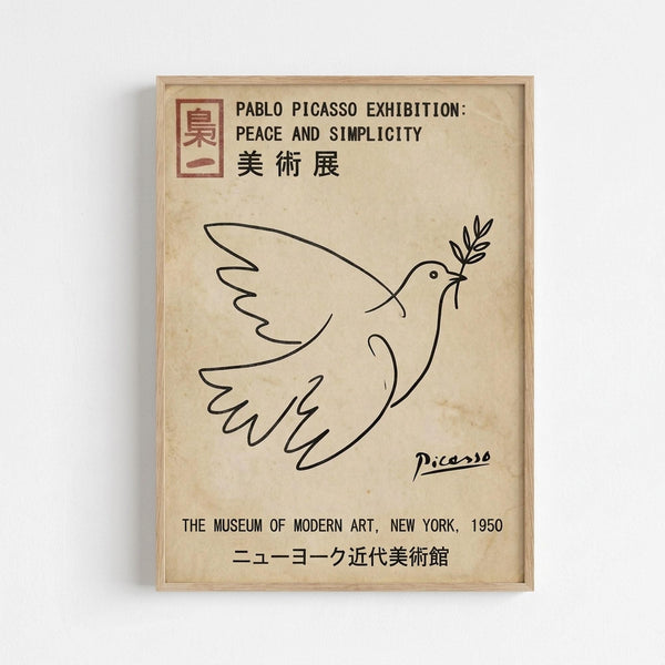 A framed poster featuring Picasso's minimalist line drawing of a dove carrying an olive branch in its beak, rendered in simple black lines on aged cream paper. The poster includes exhibition text in English and Japanese characters, with "Peace and Simplicity" prominently displayed at the top, Picasso's signature below the dove, and "The Museum of Modern Art, New York, 1950" at the bottom. The artwork is displayed in a light wooden frame against a white wall.
