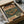 May include: Vintage-style Japanese poster print featuring retro turntable and headphones in muted green and orange color scheme, shown framed in dark wood frame, carefully packed in cardboard shipping box with protective tissue paper wrapping on wooden surface