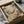May include: Framed vintage-style poster artwork in shipping box with protective wrapping, showing cartoon cats relaxing on tropical beach - one orange tabby in striped shirt on wooden chair, another sleeping in hammock between palm trees, with "CAT NAP" text and "THE ART OF DOING NOTHING" sign, sunset ocean backdrop in warm peachy tones