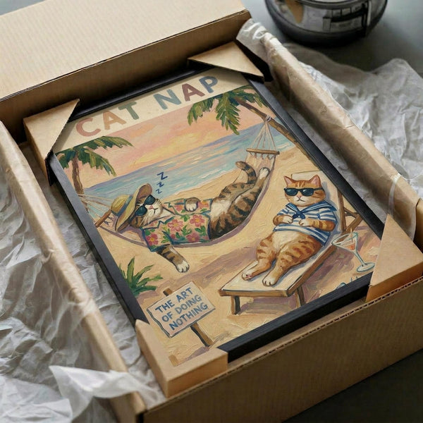 May include: Framed vintage-style poster artwork in shipping box with protective wrapping, showing cartoon cats relaxing on tropical beach - one orange tabby in striped shirt on wooden chair, another sleeping in hammock between palm trees, with "CAT NAP" text and "THE ART OF DOING NOTHING" sign, sunset ocean backdrop in warm peachy tones