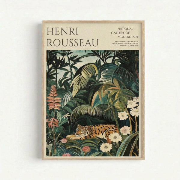 May include: Framed art print featuring Henri Rousseau's jungle scene with a spotted leopard resting among lush tropical foliage. Dense green palm fronds and leaves fill the composition with delicate white and pink flowers scattered throughout. The poster has cream-colored text at the top reading "Henri Rousseau" and "National Gallery of Modern Art" with exhibition details. Natural wood frame against white wall background.
