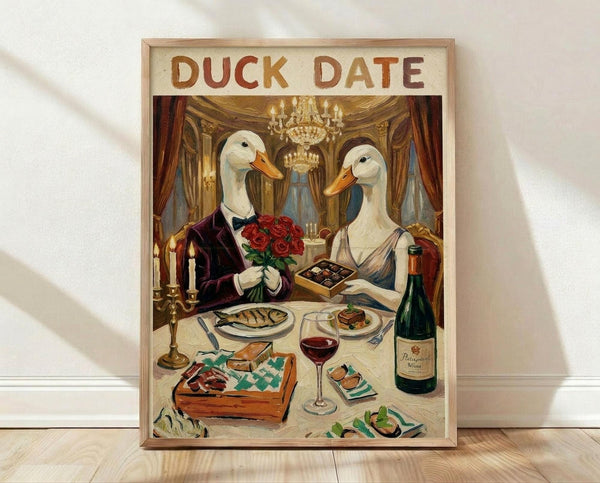May include: Framed poster print leaning against white wall on light wood floor. Artwork shows two white ducks with orange bills dressed formally - one in dark suit holding red roses, one in elegant dress. They sit at candlelit dinner table with wine, chocolates, and fine dining items in ornate room with crystal chandelier and red curtains. Vintage romantic illustration style with warm golden lighting.